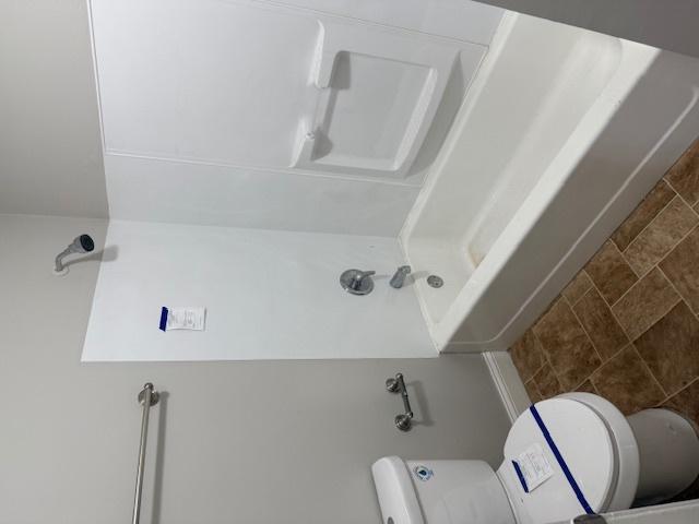 1023 N Elmwood Ave, Waukegan, IL 60085 - bathroom featuring toilet and a shower