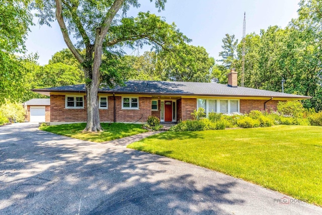 16 Yorkshire Dr, Lincolnshire, IL 60069 - ranch-style house featuring a chimney, a front yard, brick siding, and an outbuilding