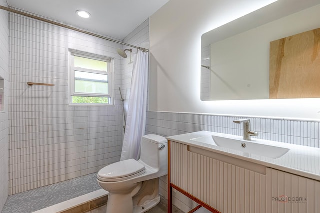 16 Yorkshire Dr, Lincolnshire, IL 60069 - bathroom featuring vanity, tiled shower, tile walls, and a wainscoted wall