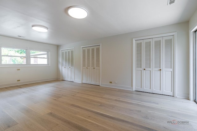 16 Yorkshire Dr, Lincolnshire, IL 60069 - unfurnished bedroom with multiple closets and light wood-style floors