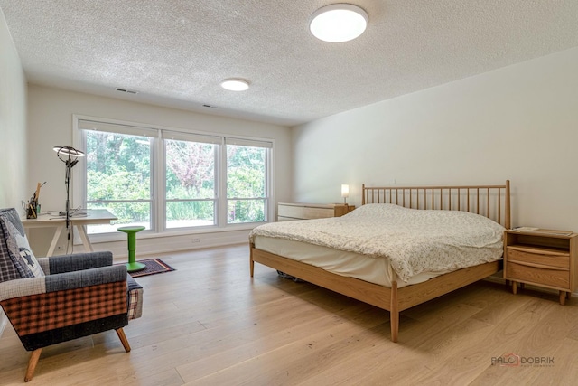16 Yorkshire Dr, Lincolnshire, IL 60069 - bedroom featuring a textured ceiling and light wood finished floors
