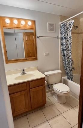 5209 S Leclaire Ave Unit 3B, Chicago, IL 60638 - bathroom with vanity, tile patterned flooring, and shower / tub combo