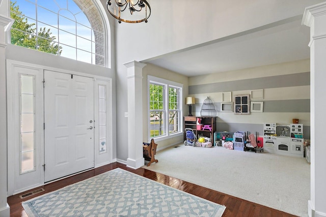 3512 Chancery Ln, Carpentersville, IL 60110 - foyer with decorative columns, wood finished floors, a chandelier, and a high ceiling