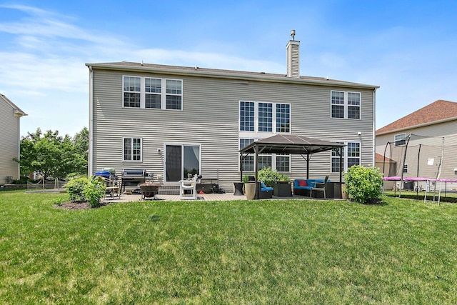 3512 Chancery Ln, Carpentersville, IL 60110 - rear view of property featuring a trampoline, a patio, an outdoor hangout area, a gazebo, and a chimney