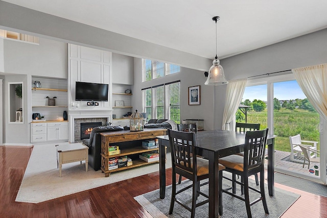 3512 Chancery Ln, Carpentersville, IL 60110 - dining room with a lit fireplace and dark wood-style floors
