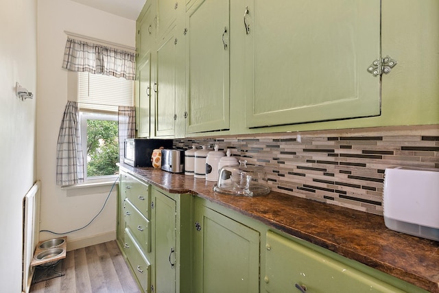 18329 Klimm Ave, Homewood, IL 60430 - kitchen with green cabinetry, dark countertops, tasteful backsplash, and wood finished floors
