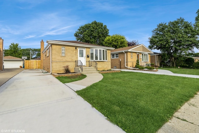 3671 Sarah St, Franklin Park, IL 60131 - view of front of house featuring brick siding, a chimney, and driveway