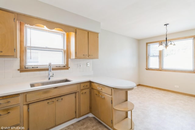 3671 Sarah St, Franklin Park, IL 60131 - kitchen featuring light flooring, a peninsula, backsplash, light countertops, and a chandelier
