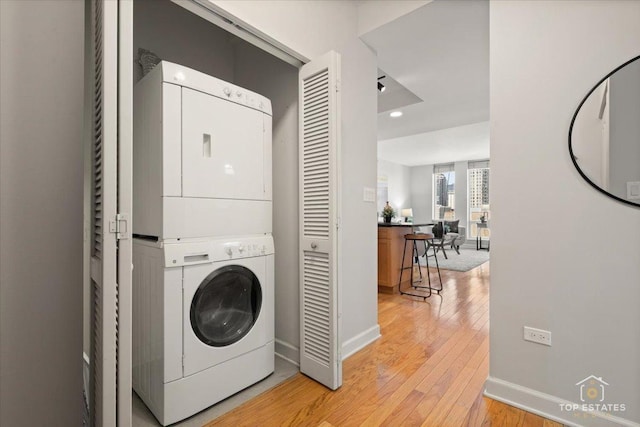 1250 S Michigan Ave Unit 1007, Chicago, IL 60605 - washroom featuring stacked washer and clothes dryer, light wood-style flooring, and recessed lighting