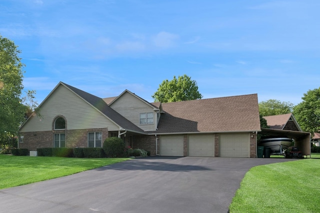 19466 W Aspen Dr, Mundelein, IL 60060 - traditional-style house featuring brick siding, asphalt driveway, and a front yard