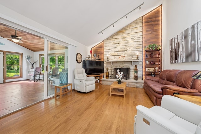 19466 W Aspen Dr, Mundelein, IL 60060 - living area featuring track lighting, light wood-style flooring, a ceiling fan, a stone fireplace, and high vaulted ceiling