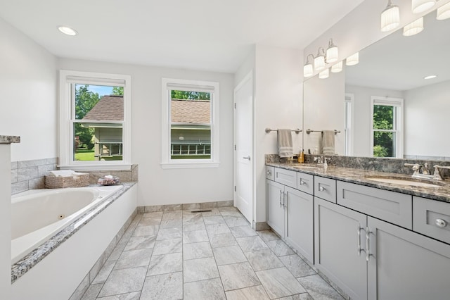 19466 W Aspen Dr, Mundelein, IL 60060 - full bath with double vanity, a jetted tub, marble finish flooring, and recessed lighting