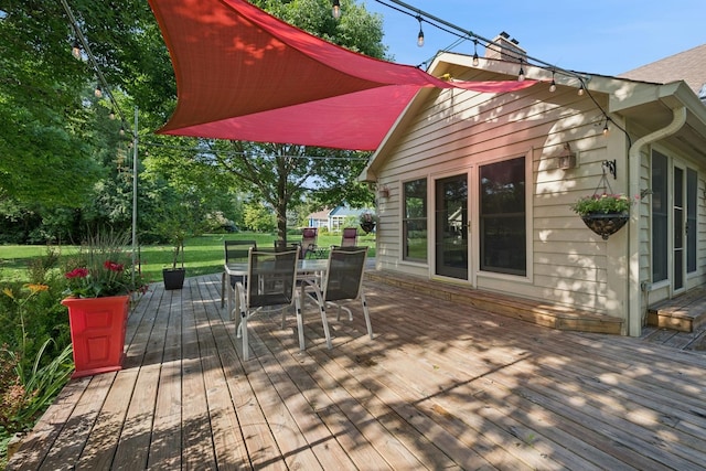 19466 W Aspen Dr, Mundelein, IL 60060 - wooden deck with outdoor dining area and a lawn