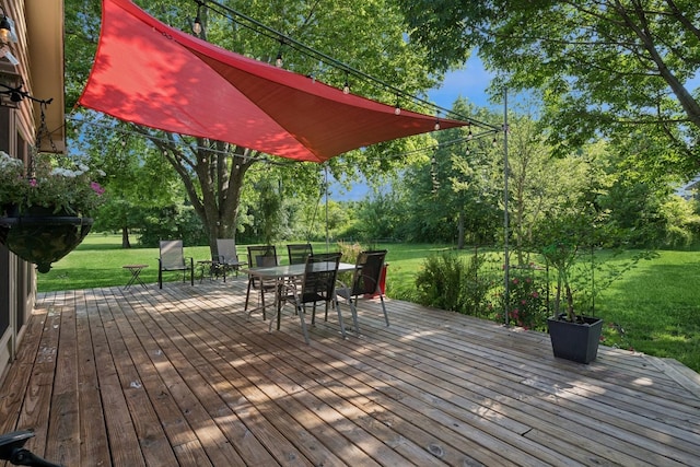 19466 W Aspen Dr, Mundelein, IL 60060 - deck featuring outdoor dining area, a lawn, and view of scattered trees