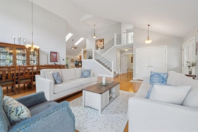 19466 W Aspen Dr, Mundelein, IL 60060 - living room featuring light wood-type flooring, stairs, a skylight, high vaulted ceiling, and a ceiling fan