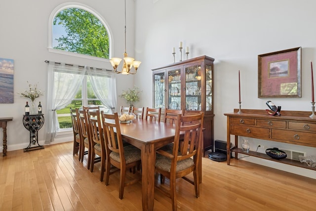 19466 W Aspen Dr, Mundelein, IL 60060 - dining area featuring a high ceiling, a chandelier, and light wood-style flooring