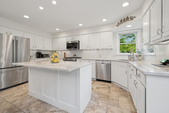 19466 W Aspen Dr, Mundelein, IL 60060 - kitchen with appliances with stainless steel finishes, decorative backsplash, white cabinets, light stone counters, and recessed lighting
