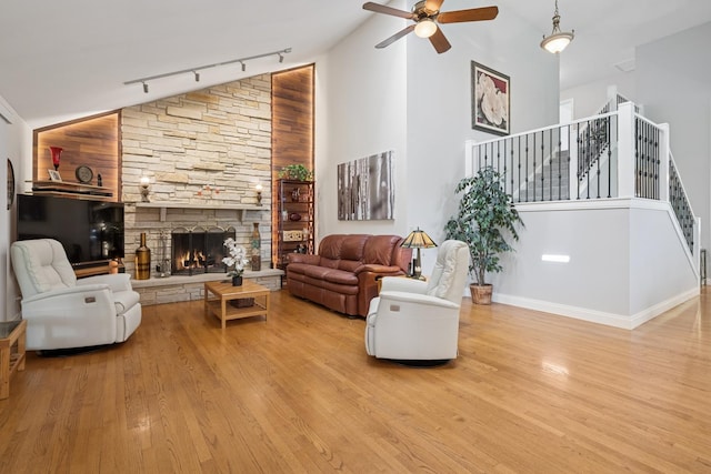 19466 W Aspen Dr, Mundelein, IL 60060 - living area featuring track lighting, a ceiling fan, stairs, high vaulted ceiling, and wood finished floors