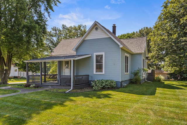 206 W N St, Leroy, IL 61752 - view of front of house with a chimney, covered porch, a front yard, and a shingled roof