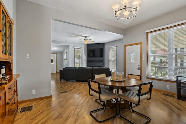 206 W N St, Leroy, IL 61752 - dining room with light wood-style flooring, a chandelier, and a ceiling fan