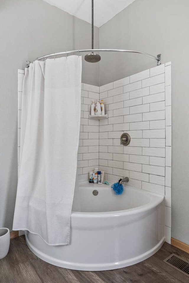 206 W N St, Leroy, IL 61752 - bathroom featuring wood finished floors, shower / tub combo, and lofted ceiling