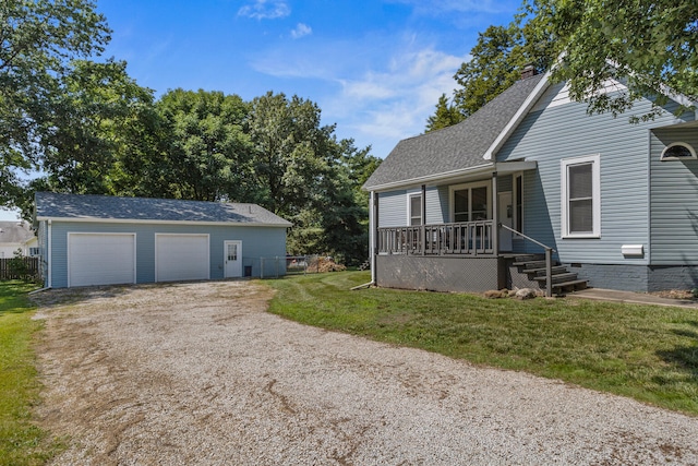 206 W N St, Leroy, IL 61752 - view of front of house featuring a porch, an outdoor structure, a shingled roof, a front yard, and a detached garage