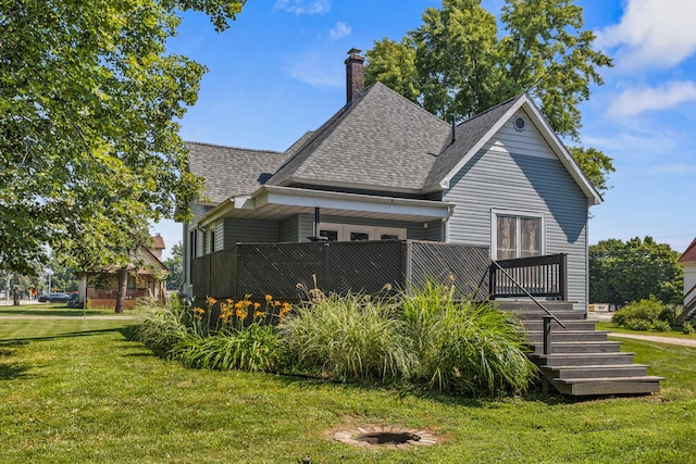 206 W N St, Leroy, IL 61752 - back of house featuring roof with shingles, a yard, and a chimney