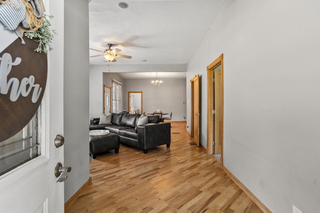 206 W N St, Leroy, IL 61752 - living room with ceiling fan, light wood-style flooring, and a chandelier