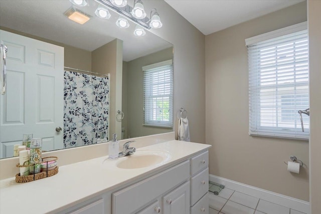 2236 Boulder Dr, Normal, IL 61761 - bathroom with plenty of natural light, vanity, tile patterned floors, and a shower with shower curtain