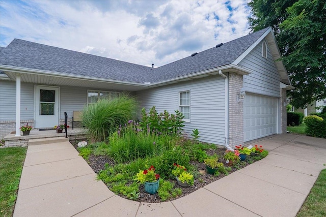 2236 Boulder Dr, Normal, IL 61761 - view of front facade featuring a shingled roof, brick siding, covered porch, concrete driveway, and a garage