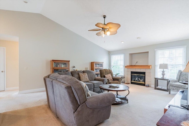 2236 Boulder Dr, Normal, IL 61761 - living area with light carpet, vaulted ceiling, a ceiling fan, and a tile fireplace