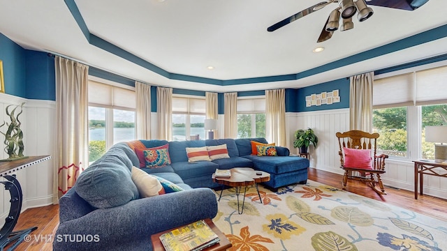 25333 W Richmond Ave, Antioch, IL 60002 - living area featuring ceiling fan, a wainscoted wall, wood finished floors, a decorative wall, and a water view