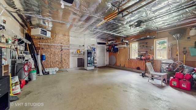 25333 W Richmond Ave, Antioch, IL 60002 - garage featuring wooden walls, a workshop area, and a garage door opener