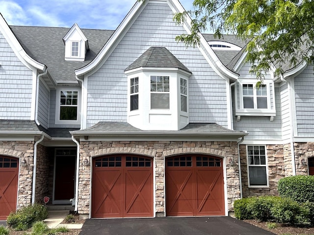 21946 W Tori Ln, Deer Park, IL 60010 - view of front facade with an attached garage, stone siding, asphalt driveway, and roof with shingles