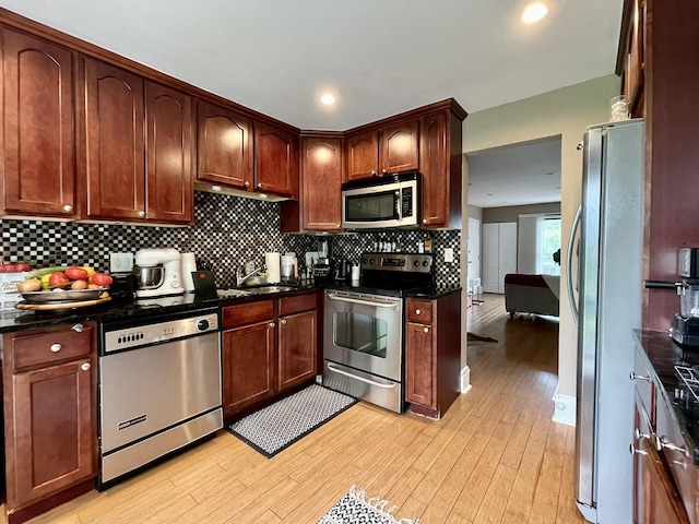 5511 Chateau Dr Unit 5, Rolling Meadows, IL 60008 - kitchen with appliances with stainless steel finishes, light wood finished floors, decorative backsplash, recessed lighting, and dark stone counters