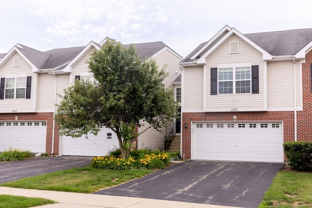 1077 Marcello Dr, Hampshire, IL 60140 - view of front facade featuring brick siding, asphalt driveway, and an attached garage