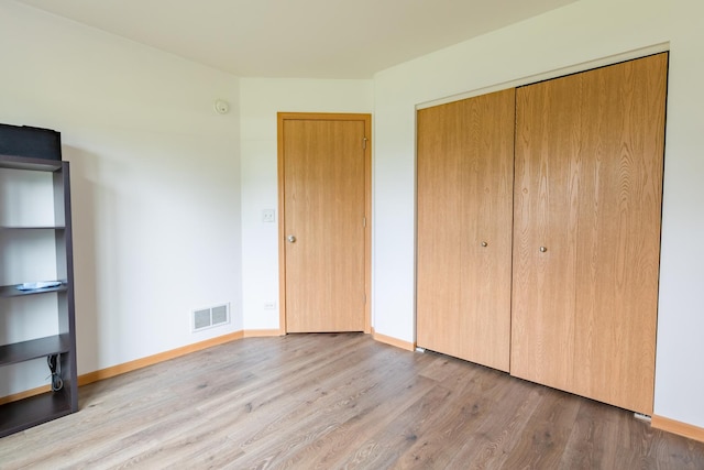 1077 Marcello Dr, Hampshire, IL 60140 - unfurnished bedroom featuring wood finished floors and a closet