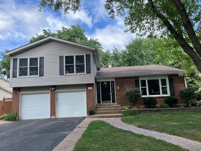 1312 Frederick Ln, Naperville, IL 60565 - tri-level home featuring brick siding, asphalt driveway, a garage, a front yard, and entry steps
