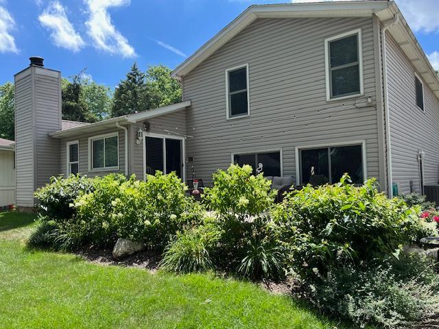 1312 Frederick Ln, Naperville, IL 60565 - back of house featuring a lawn and a chimney