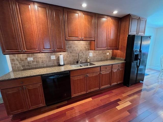 1312 Frederick Ln, Naperville, IL 60565 - kitchen with black appliances, wood finished floors, decorative backsplash, light stone counters, and recessed lighting