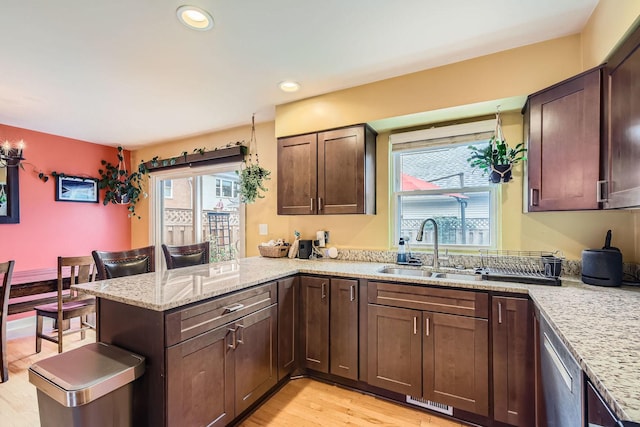 5404 N Hoyne Ave Unit 5404, Chicago, IL 60625 - kitchen with a peninsula, healthy amount of natural light, light wood-style flooring, light stone countertops, and recessed lighting