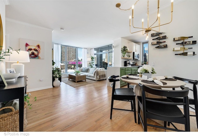 600 N Dearborn St Unit 701, Chicago, IL 60654 - dining area featuring light wood-style floors, a chandelier, ornamental molding, and floor to ceiling windows