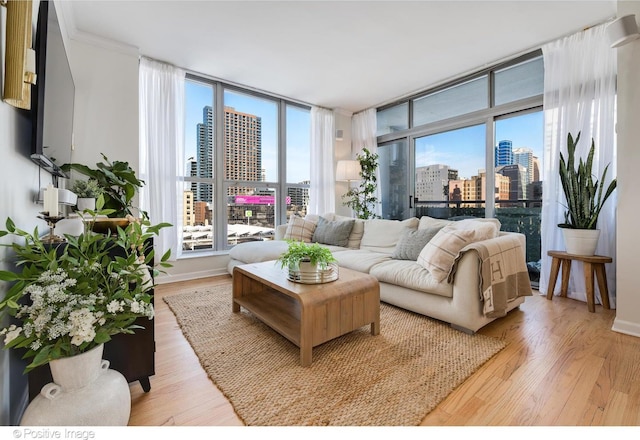 600 N Dearborn St Unit 701, Chicago, IL 60654 - living room featuring a view of skyline, light wood-style floors, plenty of natural light, and ornamental molding