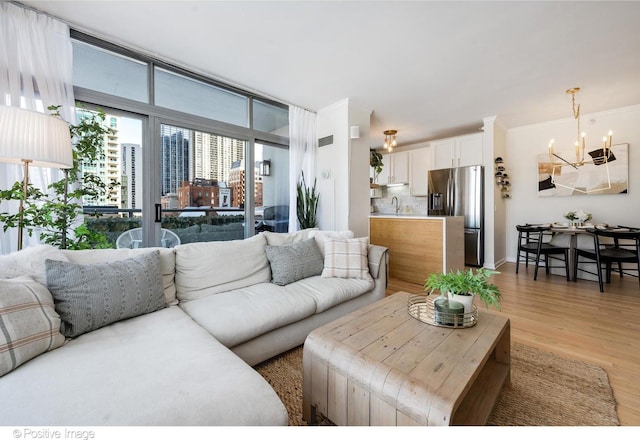 600 N Dearborn St Unit 701, Chicago, IL 60654 - living area with a chandelier and light wood-style flooring