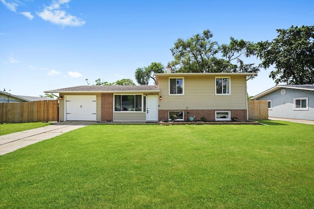 9451 Elm Ave, Mokena, IL 60448 - tri-level home with concrete driveway, a garage, and brick siding