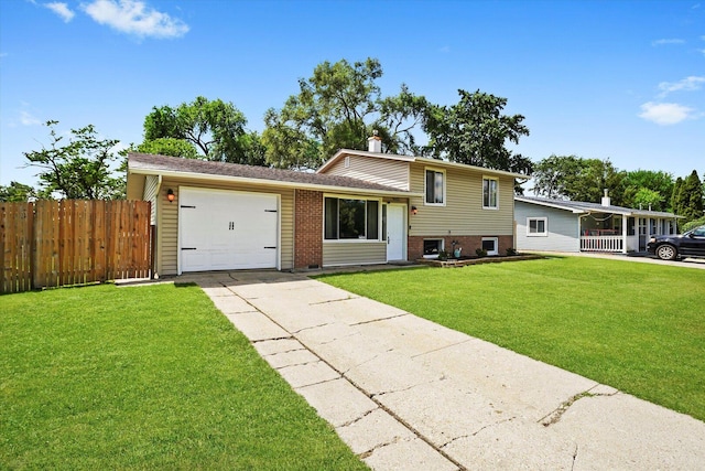 9451 Elm Ave, Mokena, IL 60448 - split level home featuring an attached garage, concrete driveway, and brick siding