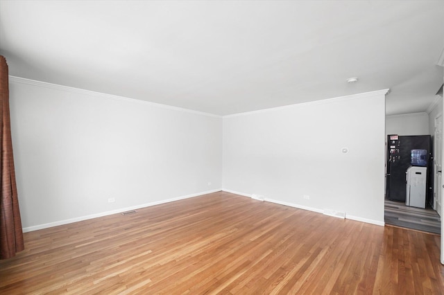 9451 Elm Ave, Mokena, IL 60448 - unfurnished living room with light wood-type flooring and ornamental molding