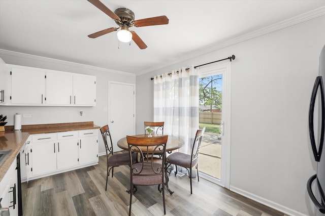 9451 Elm Ave, Mokena, IL 60448 - kitchen with ceiling fan, crown molding, light wood-type flooring, white cabinetry, and refrigerator