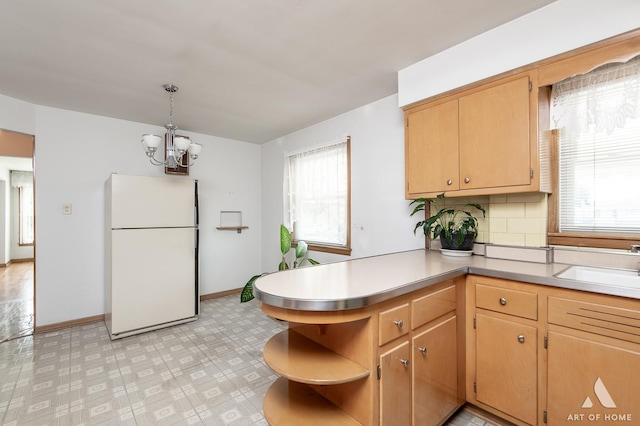 5444 S Kedvale Ave, Chicago, IL 60632 - kitchen featuring freestanding refrigerator, open shelves, a chandelier, light countertops, and decorative backsplash