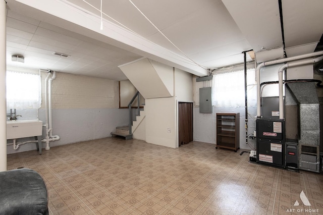 5444 S Kedvale Ave, Chicago, IL 60632 - below grade area with electric panel, healthy amount of natural light, stairway, tile patterned floors, and brick wall